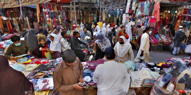 People buy garments after the government relaxed the weeks-long lockdown that was enforced to curb the spread of the coronavirus, at a market in Rawalpindi, Pakistan, Wednesday, May 13, 2020. (AP Photo/Anjum Naveed)