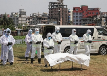 People, wearing protective suits, offer funeral prayers for a man who died due to coronavirus disease (COVID-19), before his burial at a graveyard in Dhaka, Bangladesh, April 6, 2020. REUTERS/Mohammad Ponir Hossain - RC2XYF95N1HM