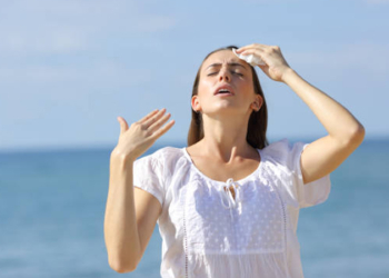 Stressed teen suffering heat stroke on the beach