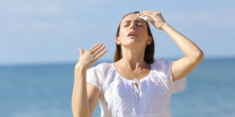 Stressed teen suffering heat stroke on the beach