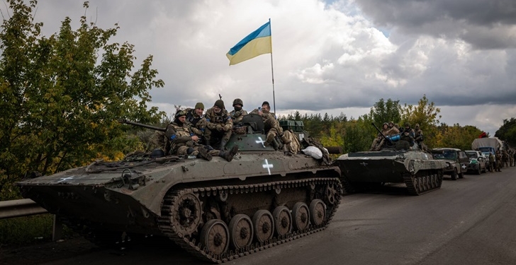 Ukrainian soldiers in armored vehicles in Izium on Saturday, Sept. 24, 2022. Ukraine’s president has urged citizens to resist the Russians in occupied territories, where voting is underway in what Western officials have called “sham” referendums on joining Russia. (Nicole Tung/The New York Times)