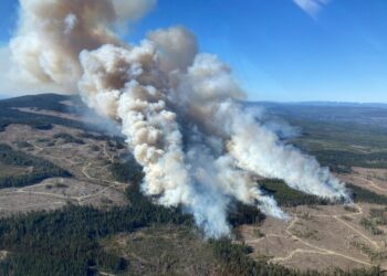 Smoke rises from the Burgess Creek wildfire