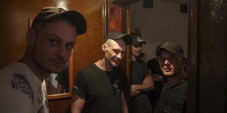 Prisoners stand in line for an interview with representatives of the Ukrainian Armed Forces in a prison, in the Dnipropetrovsk region, Ukraine, Friday, June 21, 2024.