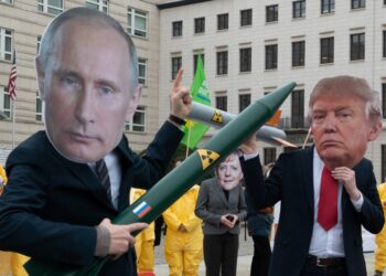 01 February 2019, Berlin: Demonstrators with a Putin and Trump mask and a Merkel mask face each other with rocket models on Pariser Platz. They are protesting with their action against the imminent end of the INF disarmament agreement between Russia and the USA. The agreement on Intermediate Range Nuclear Forces is to be dissolved by the USA. Photo: Paul Zinken/dpa