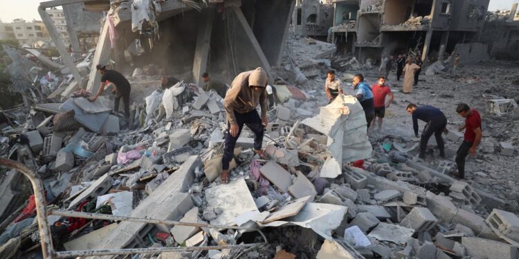 Palestinians-inspect-the-site-of-an-Israeli-strike